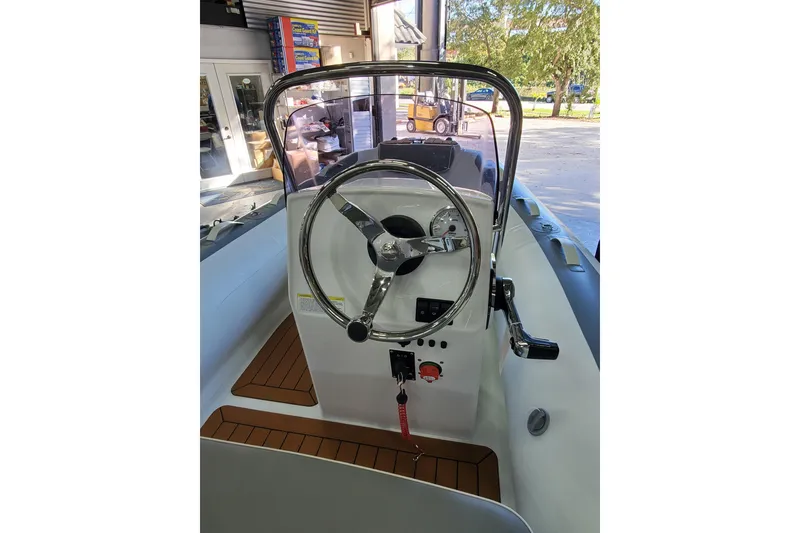 Slide: The Image of 2024 Gala A360L inflatable boat with wood accents and modern seating design. - 7