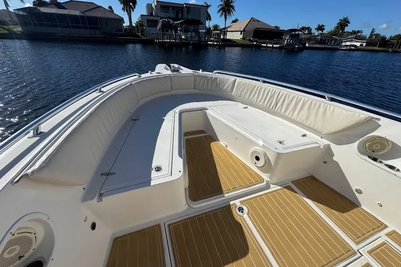 Slide: The Image of 2014 Stamas 317 Tarpon boat interior with cushioned seating and teak flooring. - 15