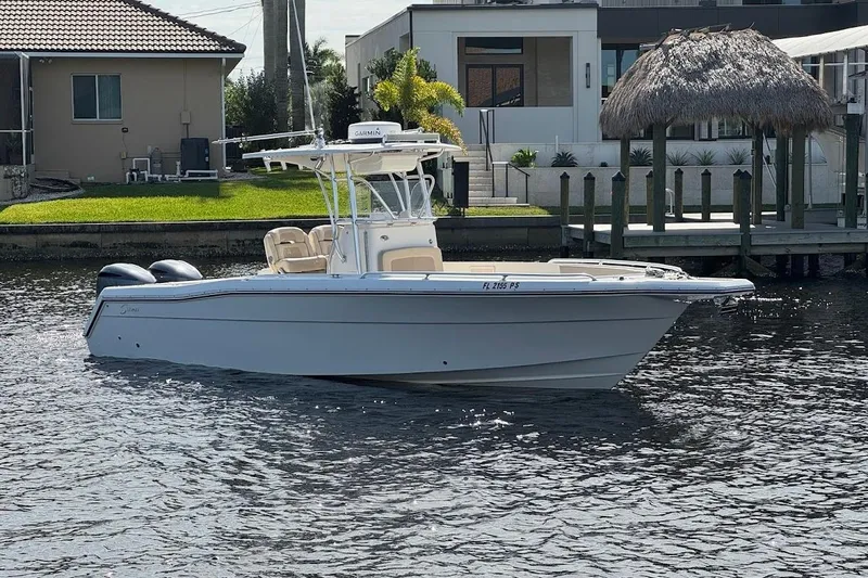 Slide: The Image of 2014 Stamas 317 Tarpon boat docked on a sunny waterfront. - 2