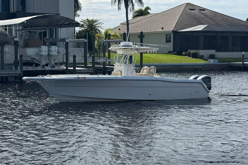 Slide: The Image of 2014 Stamas 317 Tarpon boat on calm water near a dockside home. - 3
