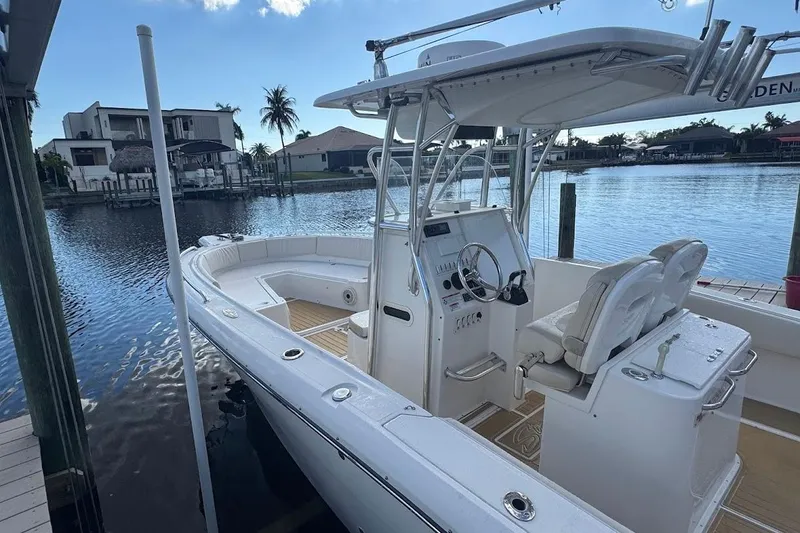 Slide: The Image of 2014 Stamas 317 Tarpon boat interior with tan cushioned seating and teak-style flooring. - 30