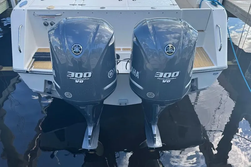 Slide: The Image of 2014 Stamas 317 Tarpon boat seat with tan cushions and teak-style flooring. - 31