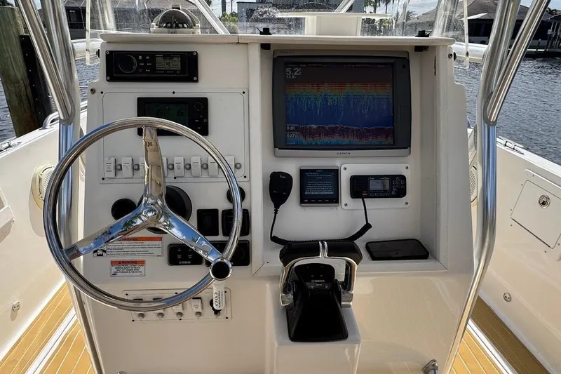 Slide: The Image of 2014 Stamas 317 Tarpon boat dashboard with steering wheel and navigation equipment. - 38