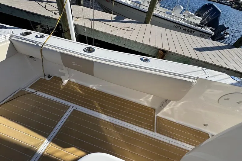Slide: The Image of 2014 Stamas 317 Tarpon boat interior with teak flooring and docked at marina. - 43