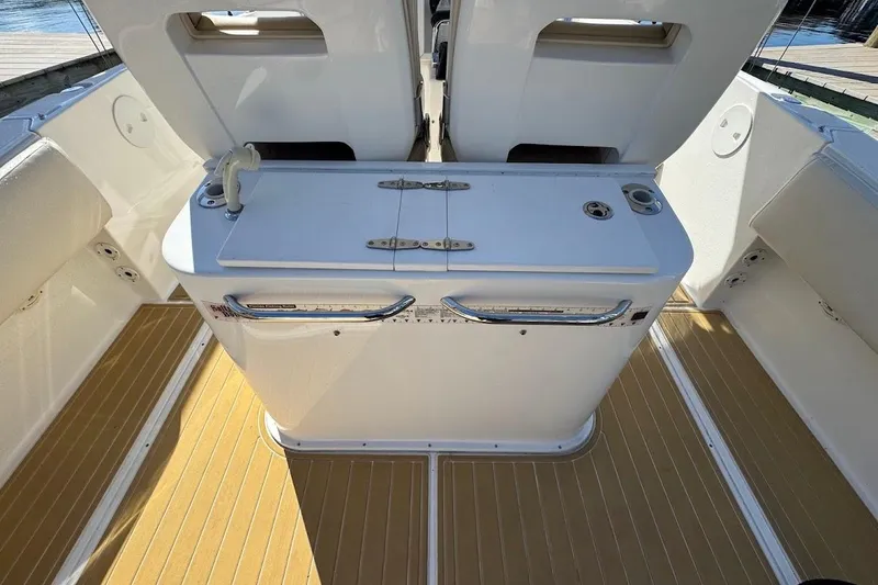 Slide: The Image of 2014 Stamas 317 Tarpon boat interior with white console and teak flooring. - 45