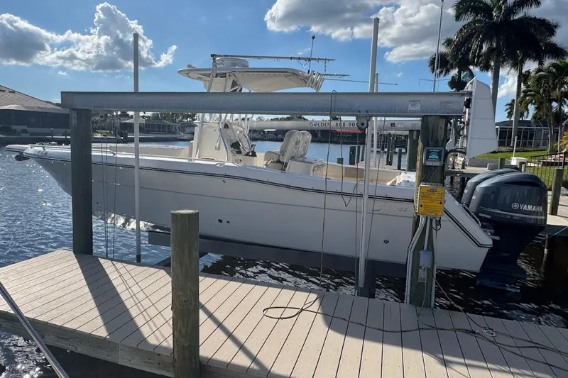 Slide: The Image of 2014 Stamas 317 Tarpon boat docked, featuring Yamaha engines, under a sunny sky. - 51