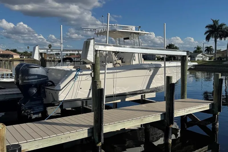 Slide: The Image of 2014 Stamas 317 Tarpon boat docked with Yamaha outboard motor, under clear skies. - 56