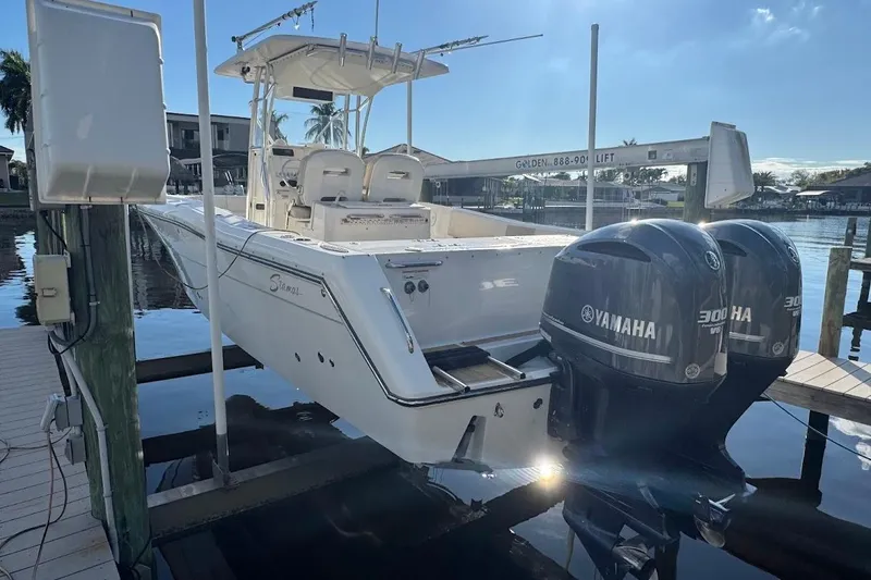 Slide: The Image of 2014 Stamas 317 Tarpon boat with dual Yamaha 300 engines docked at marina. - 58