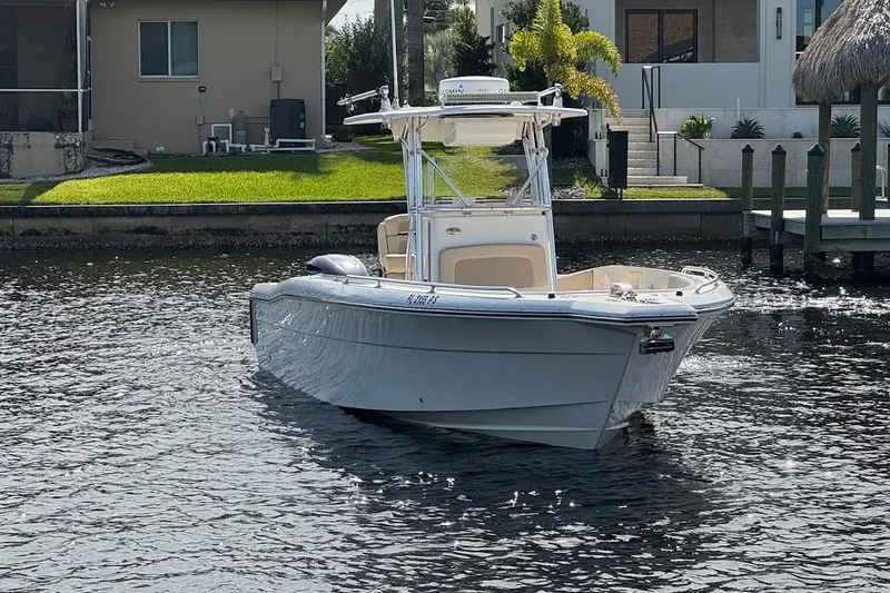 Slide: The Image of 2014 Stamas 317 Tarpon boat on calm water near residential dock. - 6