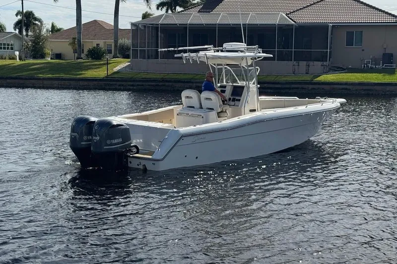 Slide: The Image of 2014 Stamas 317 Tarpon boat with dual Yamaha engines on a calm waterway. - 9