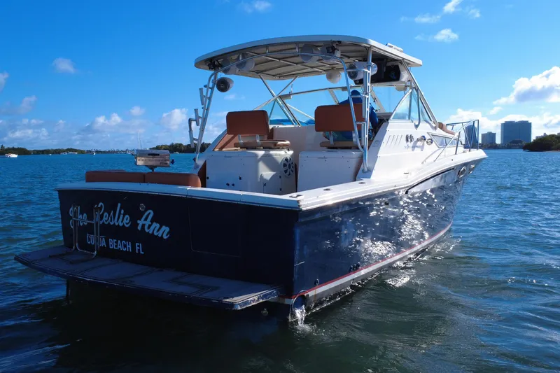 Slide: The Image of 1996 Wellcraft 330 Coastal boat on water, sunny day, blue sky, rear view. - 14