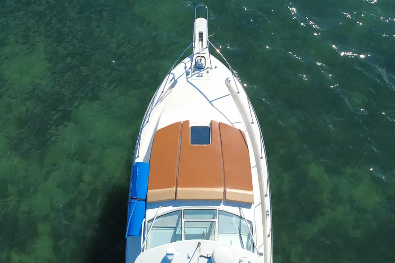 Slide: The Image of Overhead view of 1996 Wellcraft 330 Coastal boat on clear green water. - 16