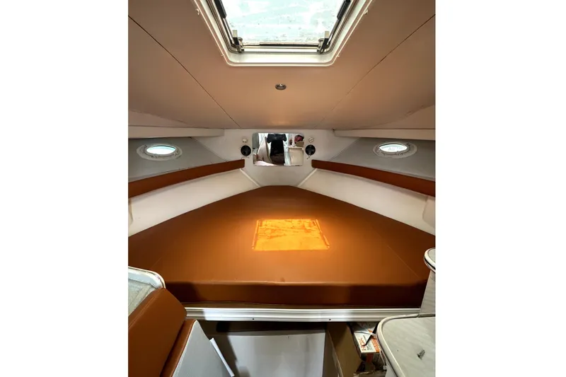 Slide: The Image of 1996 Wellcraft 330 Coastal boat deck with seating, cooler, and ocean view. - 23