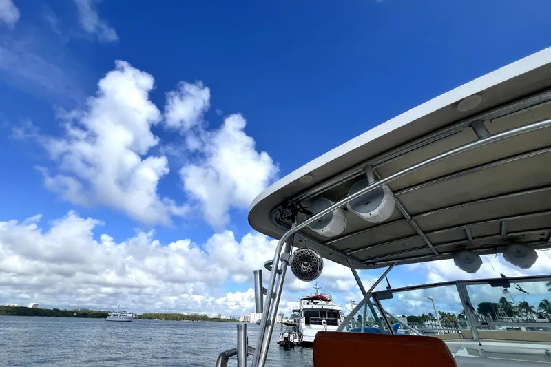 Slide: The Image of 1996 Wellcraft 330 Coastal boat roof with speakers against blue sky. - 30