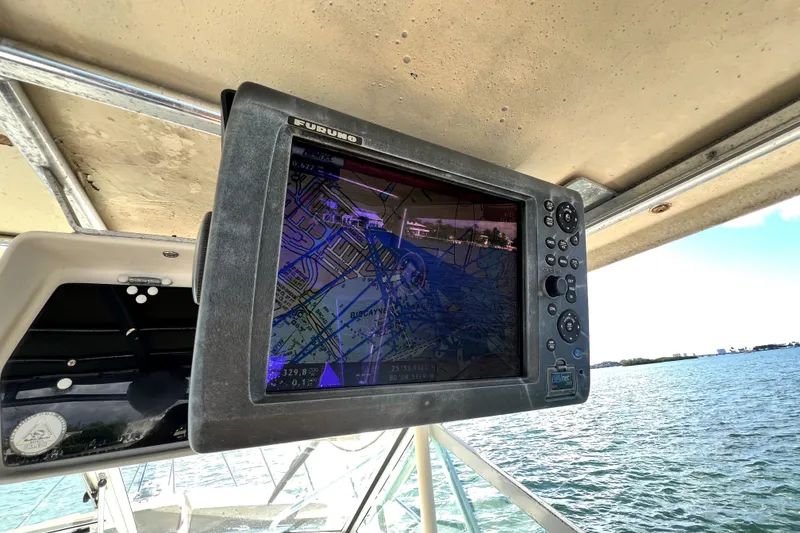 Slide: The Image of 1996 Wellcraft 330 Coastal boat with brown deck cushions on a sunny day. - 41