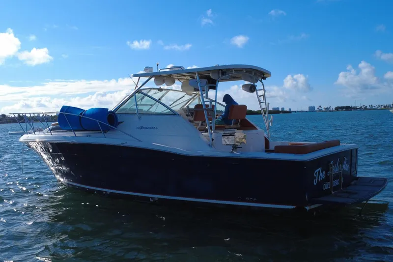 Slide: The Image of 1996 Wellcraft 330 Coastal boat on calm water under a clear blue sky. - 8