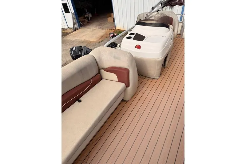 Slide: The Image of 2011 Sun Tracker Party Barge 21 Signature Series interior with beige seating and helm. - 11