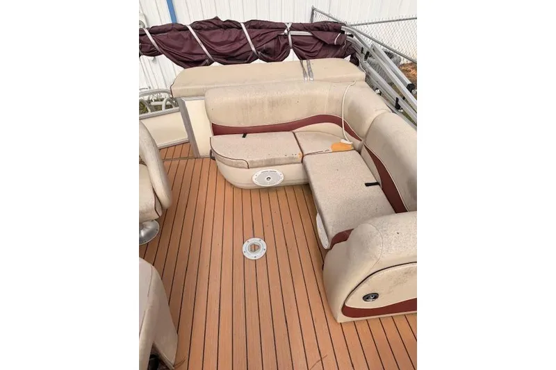 Slide: The Image of 2011 Sun Tracker Party Barge 21 Signature Series interior with beige seating and wood-like flooring. - 6