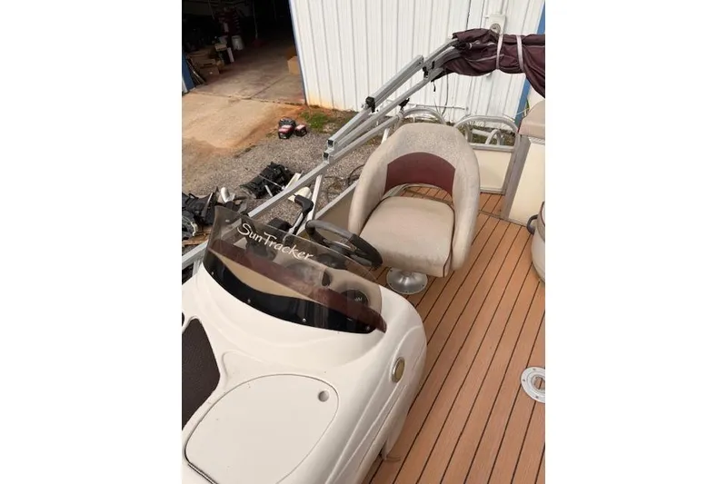 Slide: The Image of 2011 Sun Tracker Party Barge 21 Signature Series with beige seating and wood-style deck. - 7