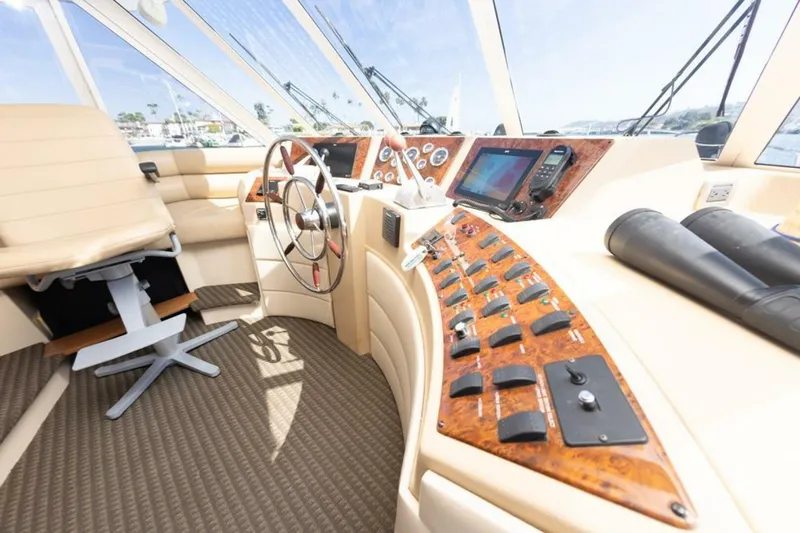 Slide: The Image of Pilothouse interior of 2004 Meridian 490, featuring steering wheel and navigation controls. - 10