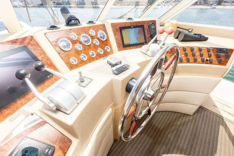 Slide: The Image of Luxurious interior of 2004 Meridian 490 Pilothouse yacht with panoramic windows and elegant furnishings. - 11
