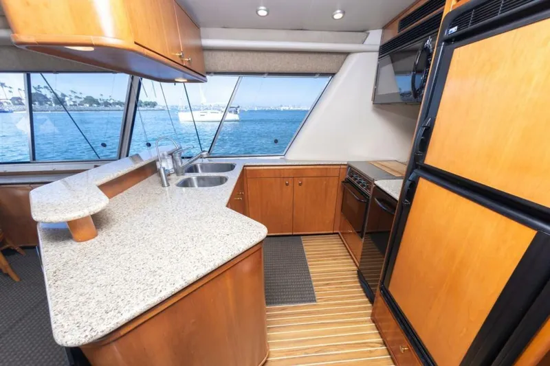 Slide: The Image of Luxurious bedroom interior of 2004 Meridian 490 Pilothouse yacht with elegant wood finish. - 14