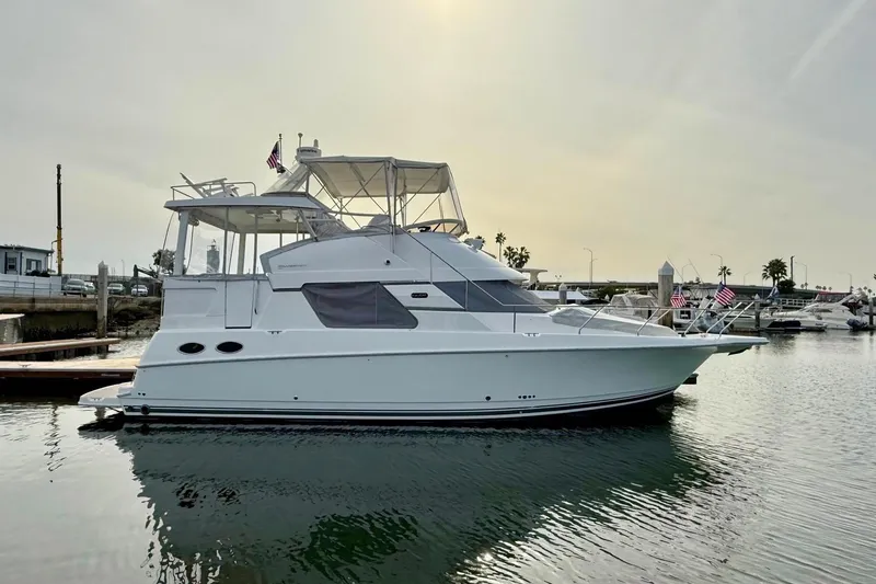 The Image of 1999 Silverton 392 Motor Yacht docked in a marina, side view. - 0