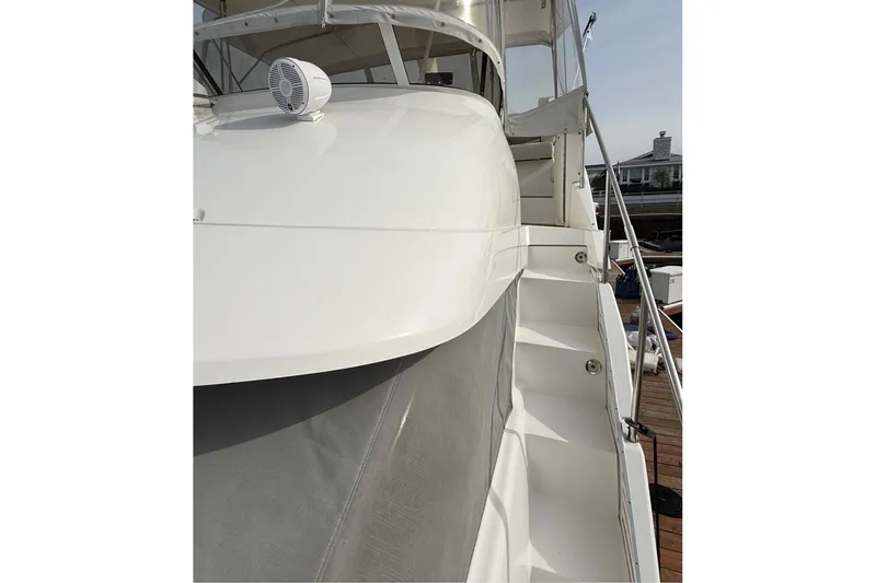 Slide: The Image of 1999 Silverton 392 Motor Yacht, white exterior, docked with visible stairs and railing. - 13