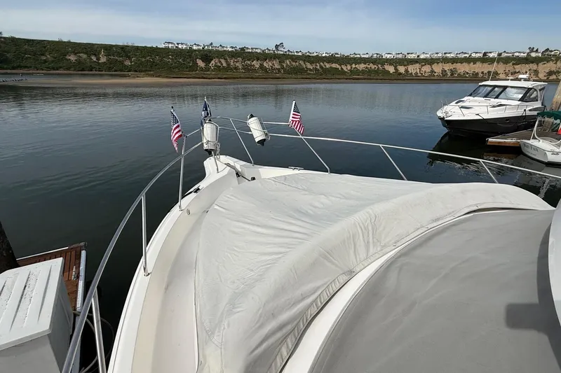 Slide: The Image of 1999 Silverton 392 Motor Yacht docked in a serene marina setting. - 15