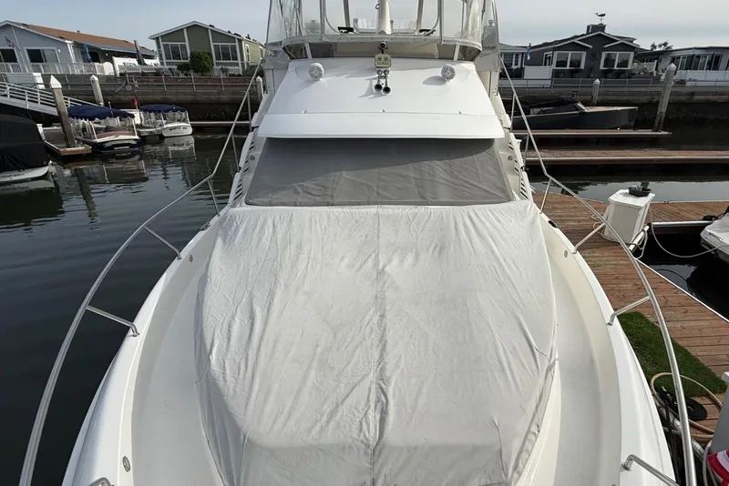 Slide: The Image of 1999 Silverton 392 Motor Yacht docked, covered with a protective tarp. - 17