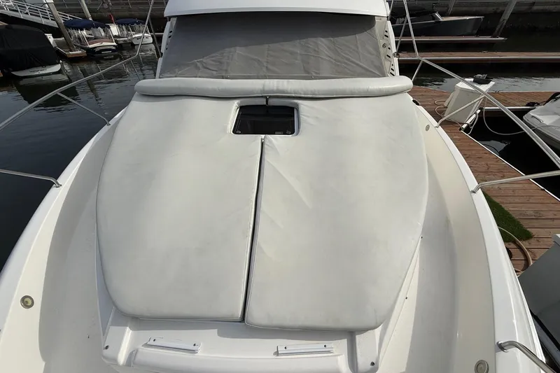 Slide: The Image of 1999 Silverton 392 Motor Yacht bow with cushioned sunpad at marina. - 18