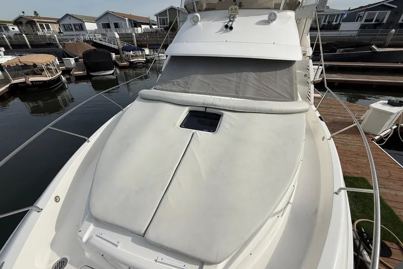 Slide: The Image of 1999 Silverton 392 Motor Yacht docked, featuring spacious deck and sleek design. - 19