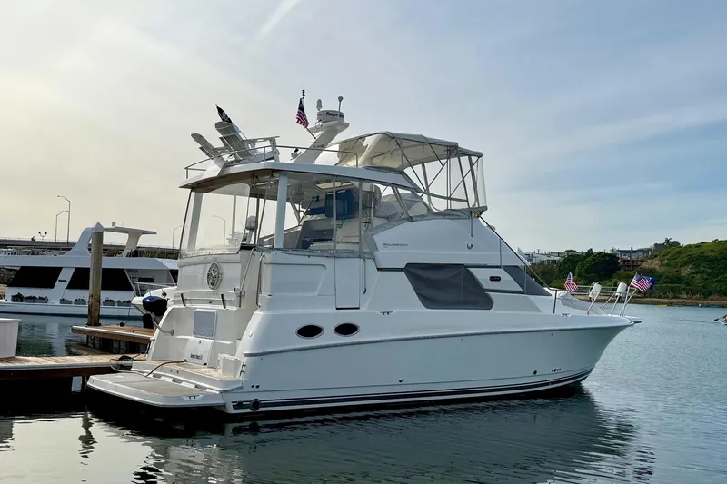 Slide: The Image of 1999 Silverton 392 Motor Yacht docked in a serene marina setting. - 2