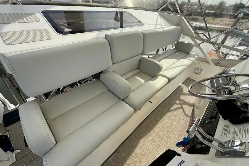 Slide: The Image of 1999 Silverton 392 Motor Yacht interior with plush seating and modern helm controls. - 23
