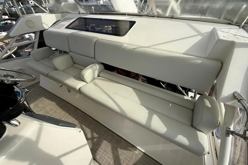 Slide: The Image of Luxurious seating area on a 1999 Silverton 392 Motor Yacht, featuring plush white cushions. - 24