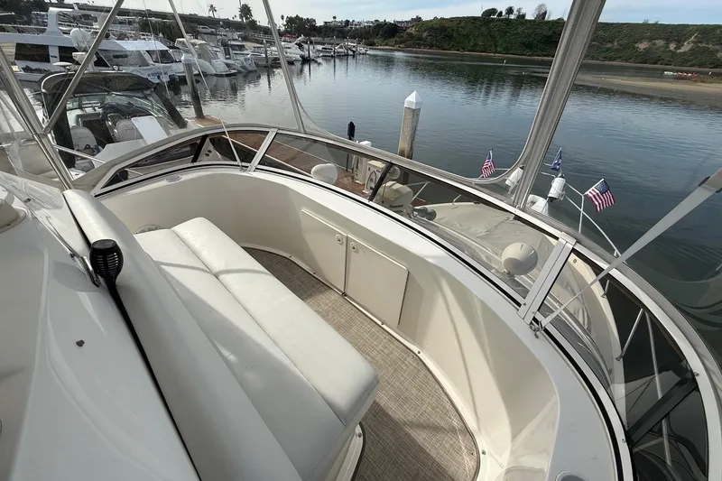 Slide: The Image of 1999 Silverton 392 Motor Yacht with spacious seating, docked in a serene marina setting. - 25