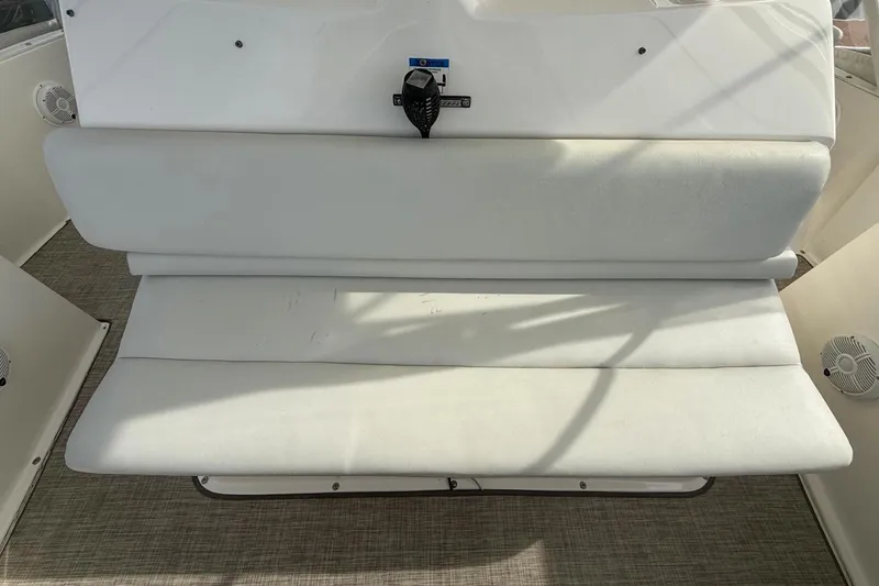 Slide: The Image of 1999 Silverton 392 Motor Yacht interior with white cushioned seating and marine speakers. - 26