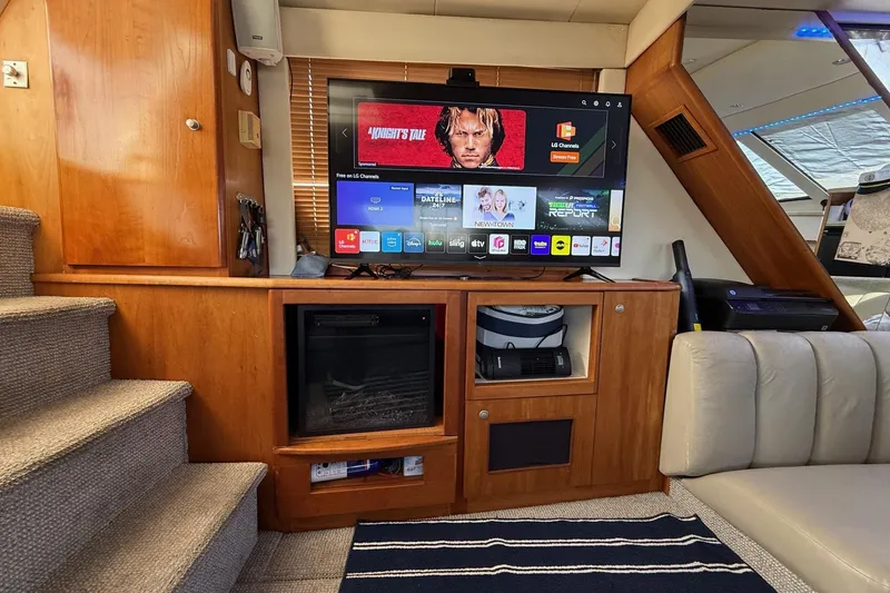Slide: The Image of Interior of 1999 Silverton 392 Motor Yacht with TV and entertainment setup. - 33