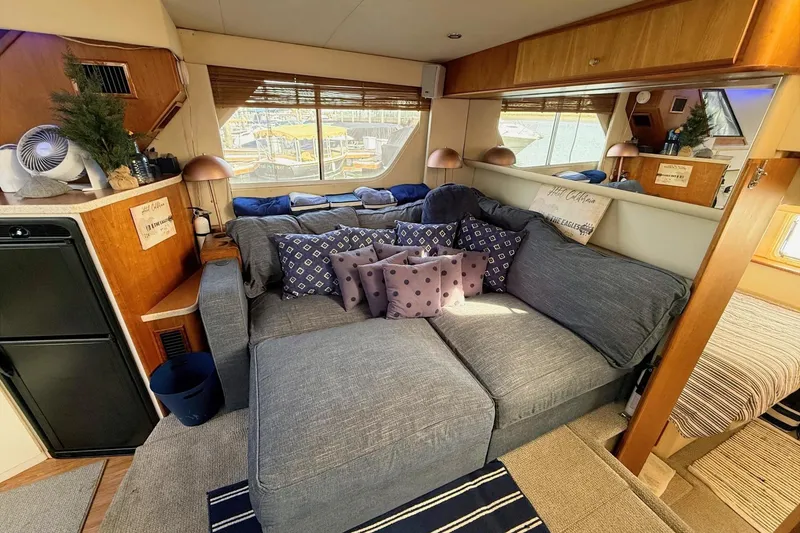 Slide: The Image of Interior of a 1999 Silverton 392 Motor Yacht with cozy seating and decorative pillows. - 34