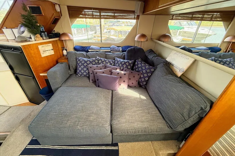 Slide: The Image of Luxurious interior of 1999 Silverton 392 Motor Yacht with cozy seating and decorative pillows. - 35