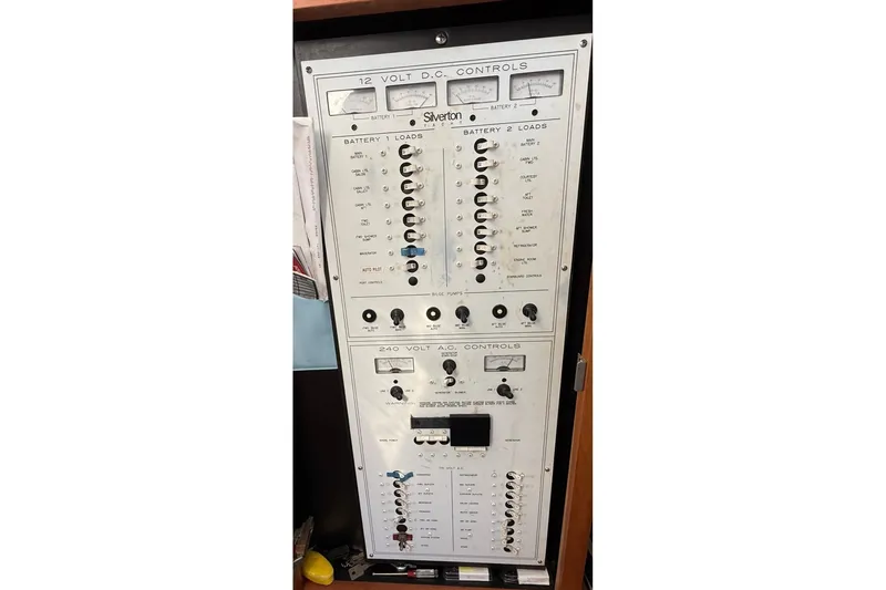 Slide: The Image of 1999 Silverton 392 Motor Yacht electrical control panel with 12V and 240V systems. - 41