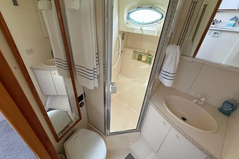 Slide: The Image of Bathroom interior of 1999 Silverton 392 Motor Yacht with shower and sink. - 51