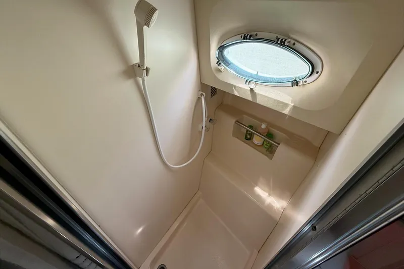 Slide: The Image of Shower area in 1999 Silverton 392 Motor Yacht with porthole and toiletries. - 52