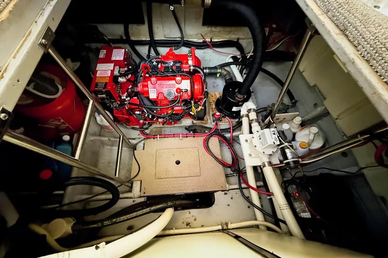 Slide: The Image of Engine room of 1999 Silverton 392 Motor Yacht with red engine and wiring. - 55