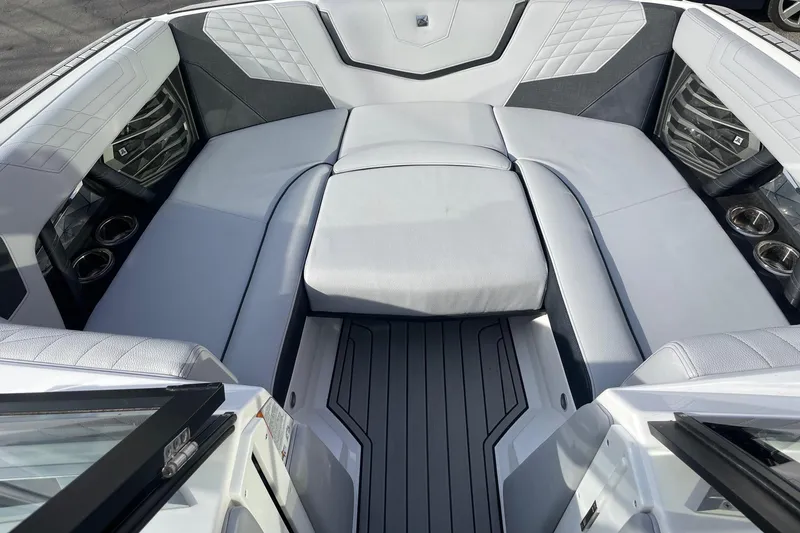 Slide: The Image of 2024 Nautique Super Air Nautique G23 boat interior with luxurious seating and cup holders. - 11