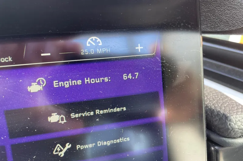 Slide: The Image of 2024 Nautique Super Air Nautique G23 dashboard displaying engine hours and speed. - 13