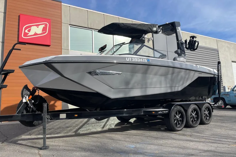 Slide: The Image of 2024 Nautique Super Air Nautique G23 boat on trailer outside dealership. - 2