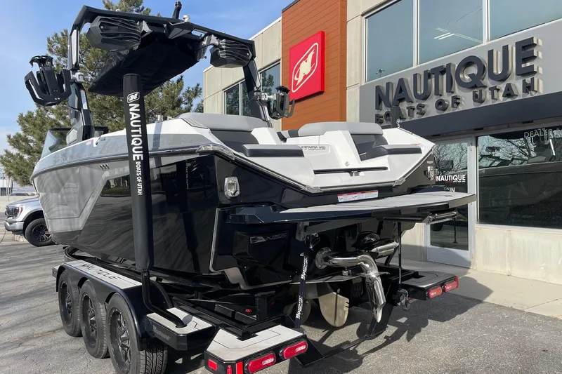 Slide: The Image of 2024 Nautique Super Air Nautique G23 boat at dealership, rear view. - 3