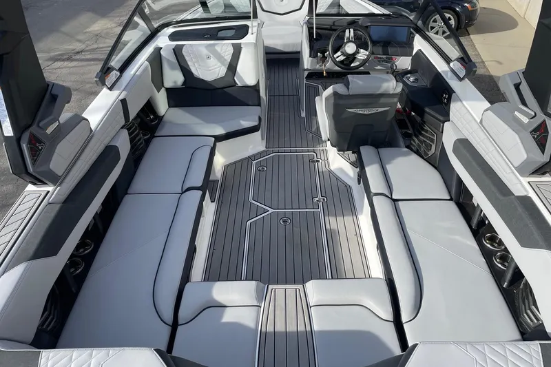Slide: The Image of 2024 Nautique Super Air Nautique G23 interior with sleek seating and modern dashboard. - 5