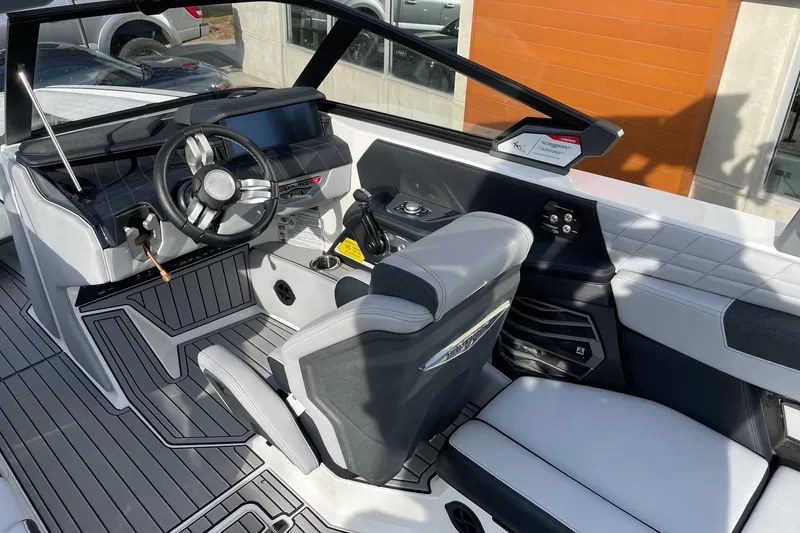 Slide: The Image of 2024 Nautique Super Air Nautique G23 boat interior with modern dashboard and seating. - 6